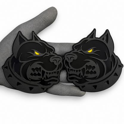 Custom pitbull automotive emblem featuring black layered construction and bright red eye accents