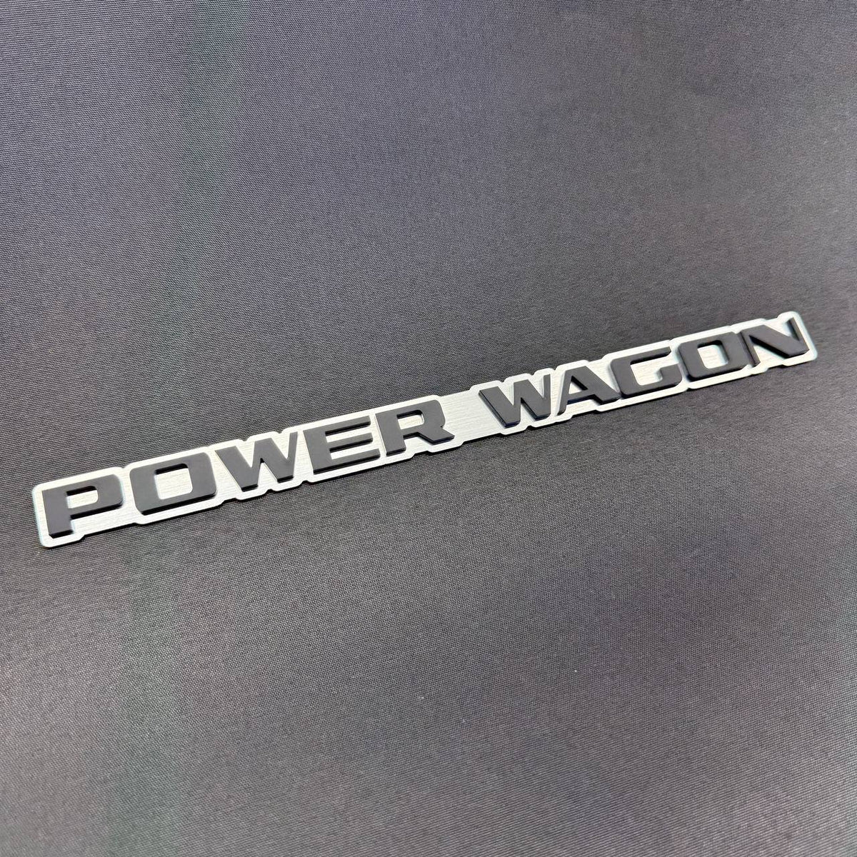 Dodge Power Wagon silver and black truck emblem with 3M automotive adhesive for flat fender, tailgate and body surfaces.