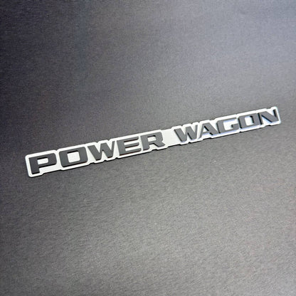 Power Wagon aftermarket decorative badge for Ram 2500 and 3500 pickup trucks, custom silver background with black lettering.
