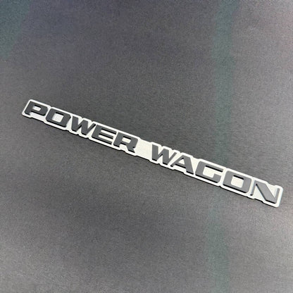 Ram Power Wagon 4WD truck tailgate nameplate emblem, double layer automotive badge with bold raised text.