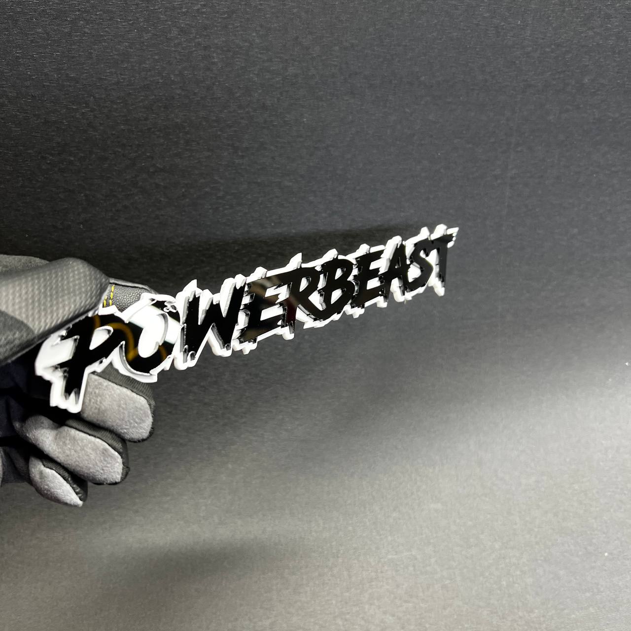 Black and white POWERBEAST performance car badge side view