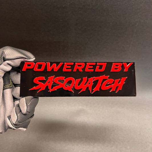 Red Powered by Sasquatch exterior badge on glossy black backing