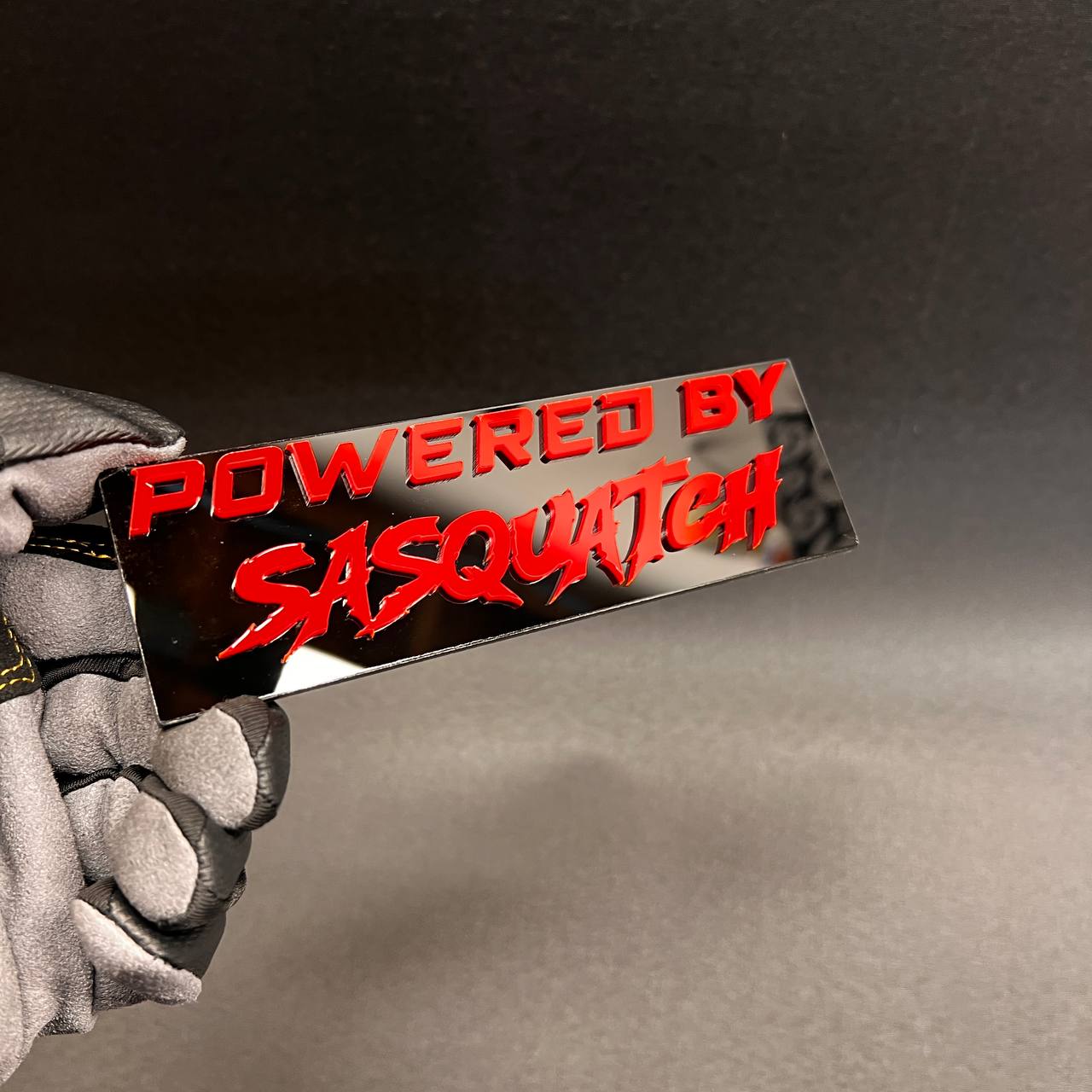 Custom Powered by Sasquatch truck badge with red raised lettering