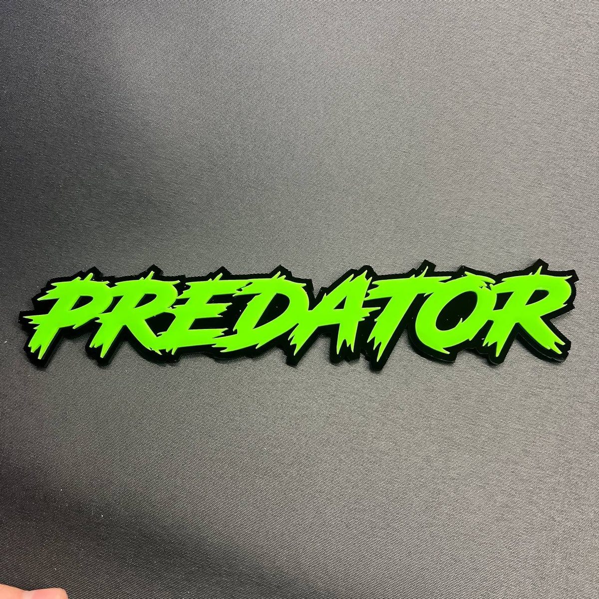 Predator automotive badge in neon green and black designed for car truck or SUV fender installation