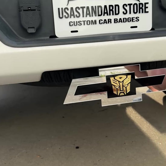 Chevrolet Bowtie hitch cover with silver finish and gold Autobot logo center