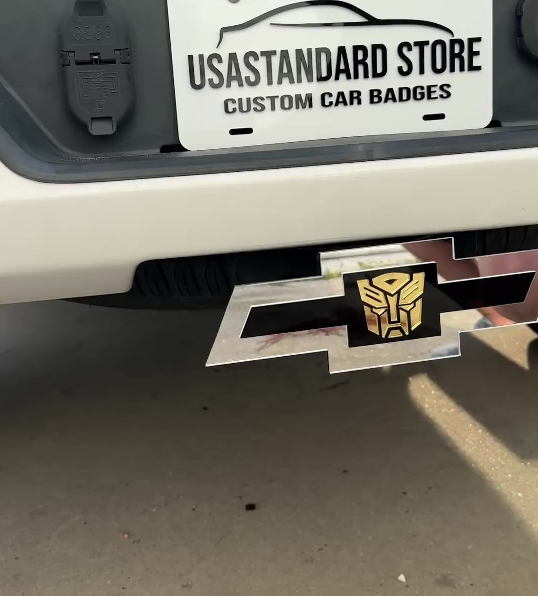 Chevrolet Bowtie hitch cover with silver finish and gold Autobot logo center