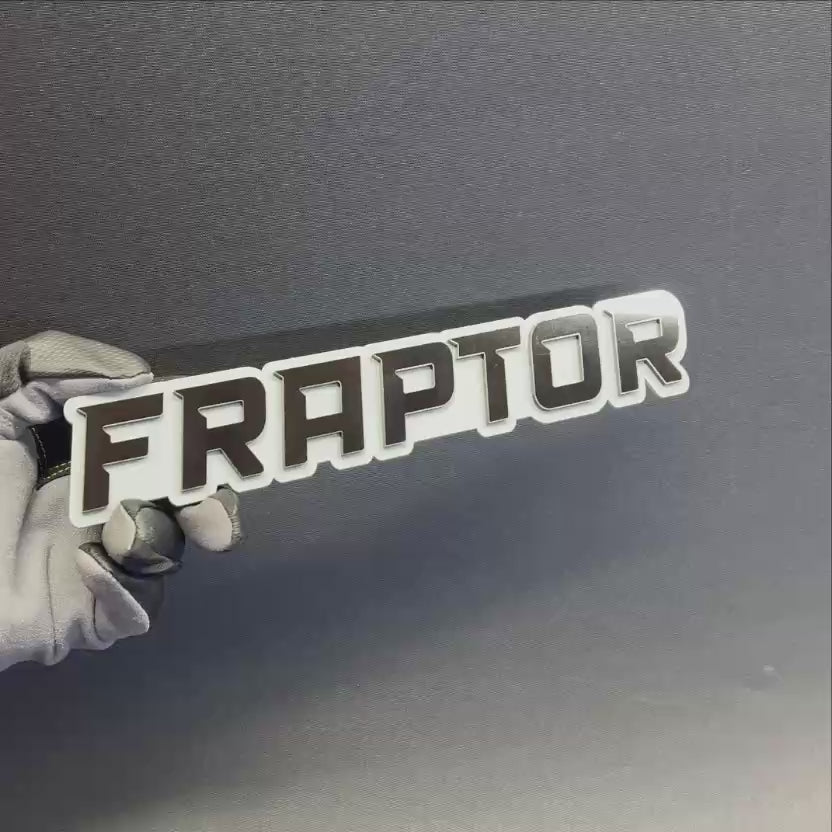 Custom FRAPTOR automotive badge with bold black lettering and white background for cars and trucks.