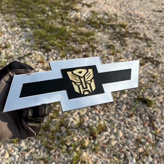 Chevrolet Bowtie emblem with silver outer finish and gold Autobot logo