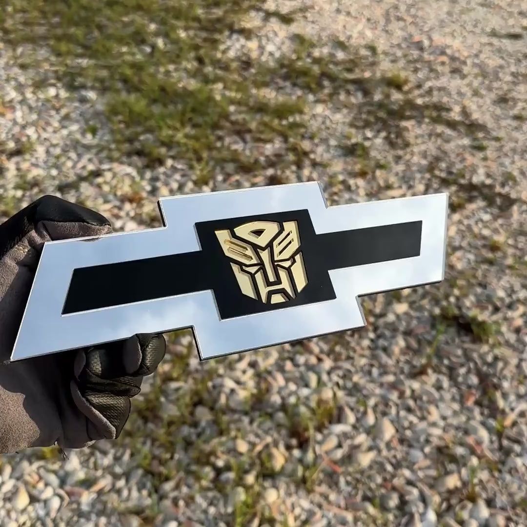 Chevrolet Bowtie emblem with silver outer finish and gold Autobot logo