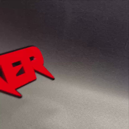 Personalized SHAKER automotive emblem with glossy red face and black outline.