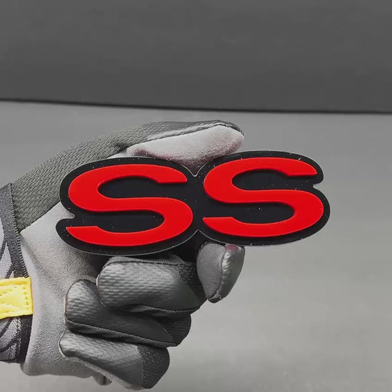 Laser-cut SS custom vehicle badge with vibrant red lettering.
