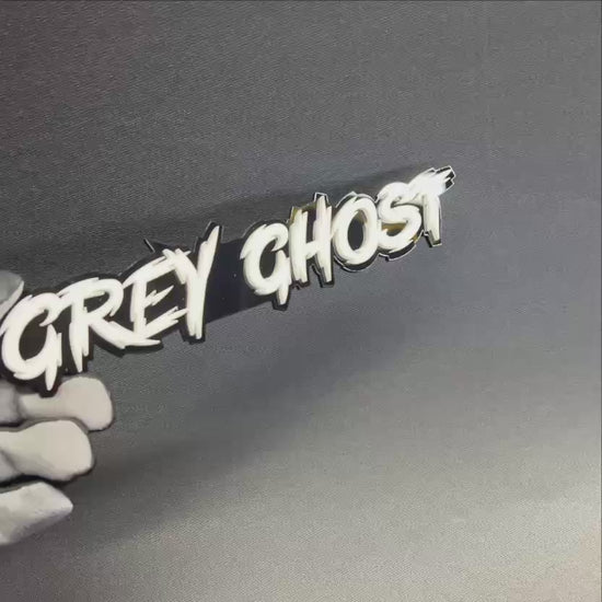 Handmade Grey Ghost vehicle badge with sharp racing-style lettering for hood, fender, trunk, or rear emblem use.