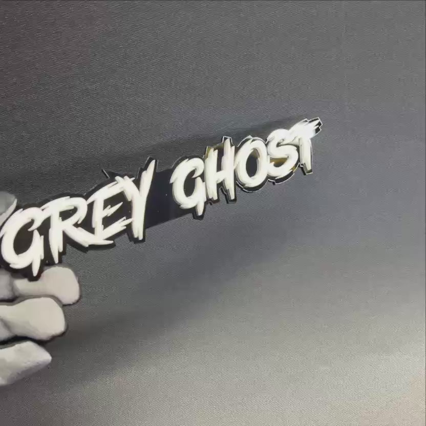 Handmade Grey Ghost vehicle badge with sharp racing-style lettering for hood, fender, trunk, or rear emblem use.