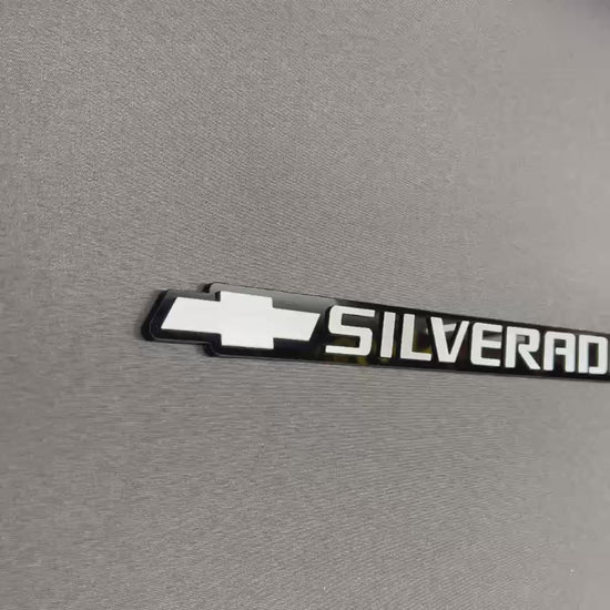 Custom Chevrolet Silverado tailgate emblem featuring silver bowtie logo and Silverado text