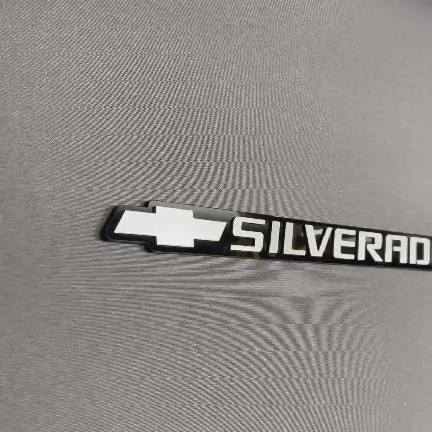 Custom Chevrolet Silverado tailgate emblem featuring silver bowtie logo and Silverado text