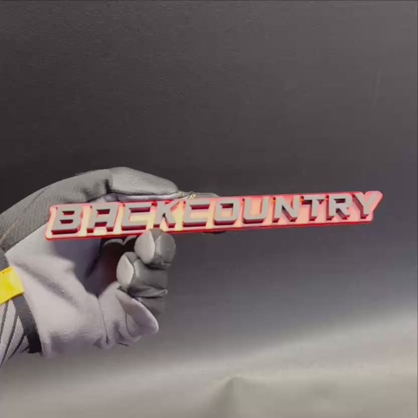 Red and silver Back Country vehicle emblem for fender or tailgate