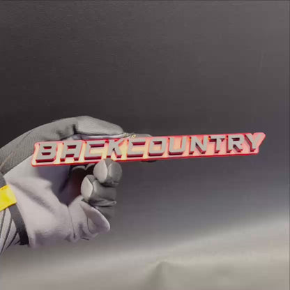 Red and silver Back Country vehicle emblem for fender or tailgate
