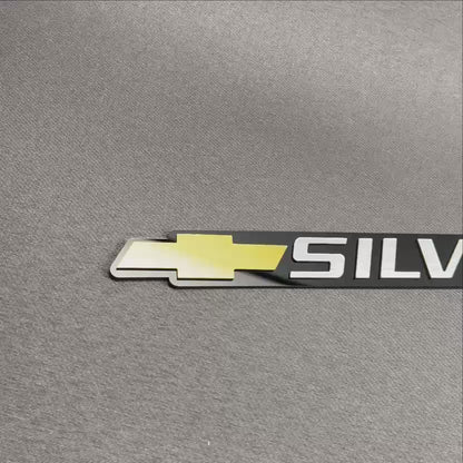 Chevrolet Silverado gold bowtie tailgate emblem for truck exterior customization.
