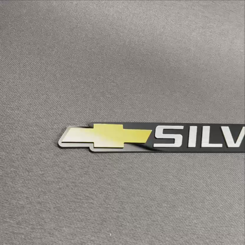 Chevrolet Silverado gold bowtie tailgate emblem for truck exterior customization.