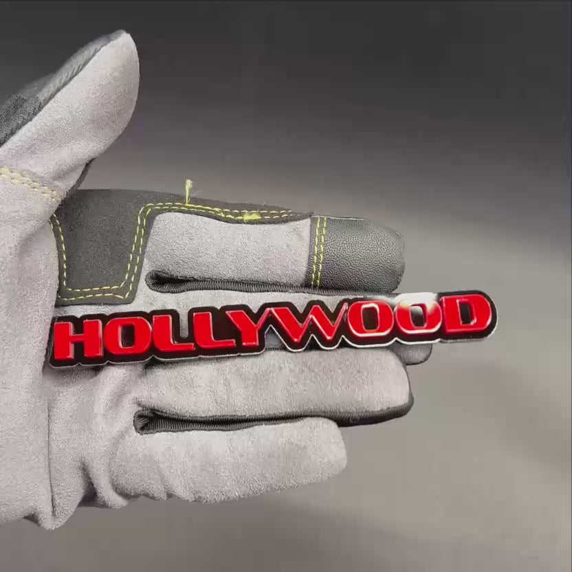 Custom HOLLYWOOD automotive text badge with red letters and black background