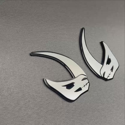 Silver and black Mudhorn fender emblem with aggressive horned design