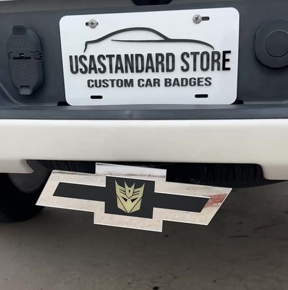 Chevy emblem silver glow in the dark Decepticon hitch cover mounted on a truck receiver