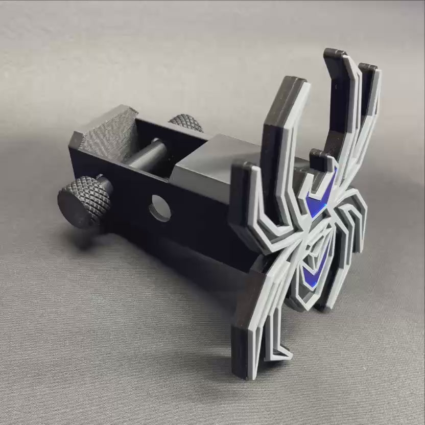 Custom Black Widow spider hitch receiver cover featuring gray outlines, black base, and mirror blue details.