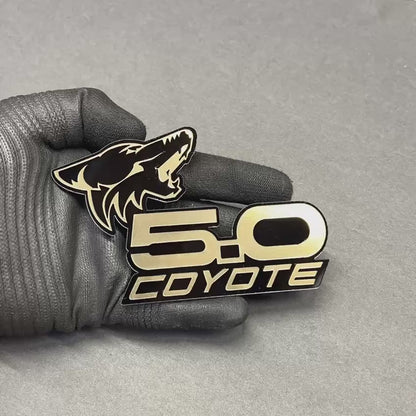 Brushed gold Coyote 5.0 emblem badge with black base for Ford Mustang GT and F150 trucks – custom acrylic car badge with premium metallic finish