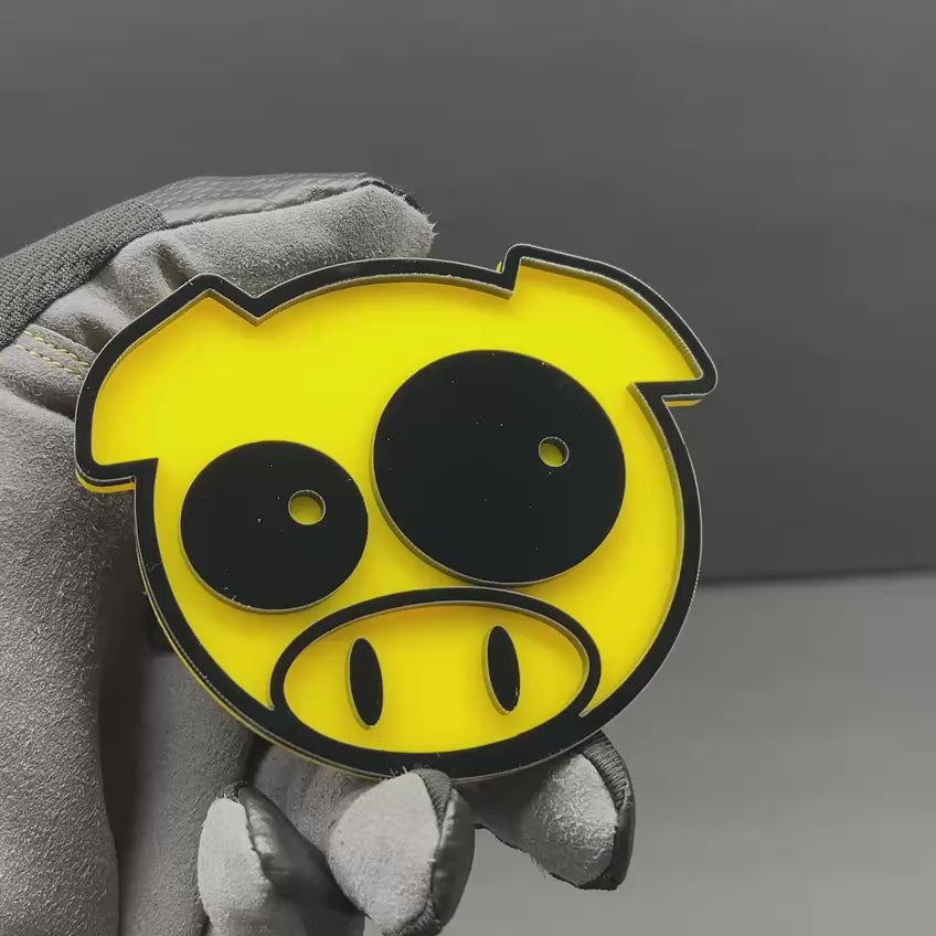 Cartoon pig vehicle emblem in yellow and black for car or truck exterior