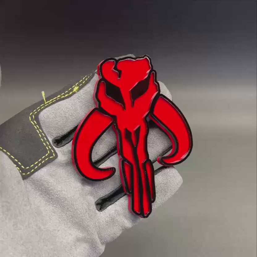 Mythosaur skull car emblem in red and black