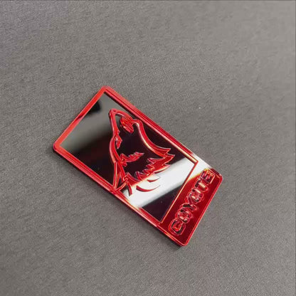 Mirror red Coyote 5.0 car grille emblem with black background