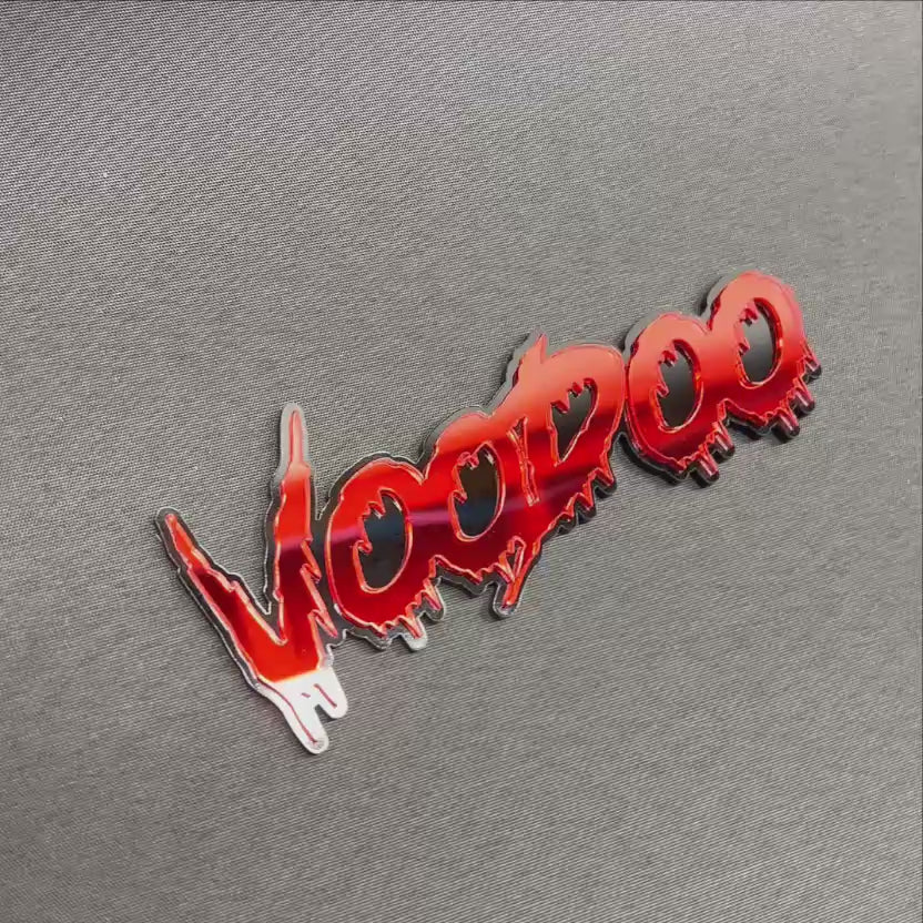VOODOO automotive exterior emblem featuring bold red dripping lettering