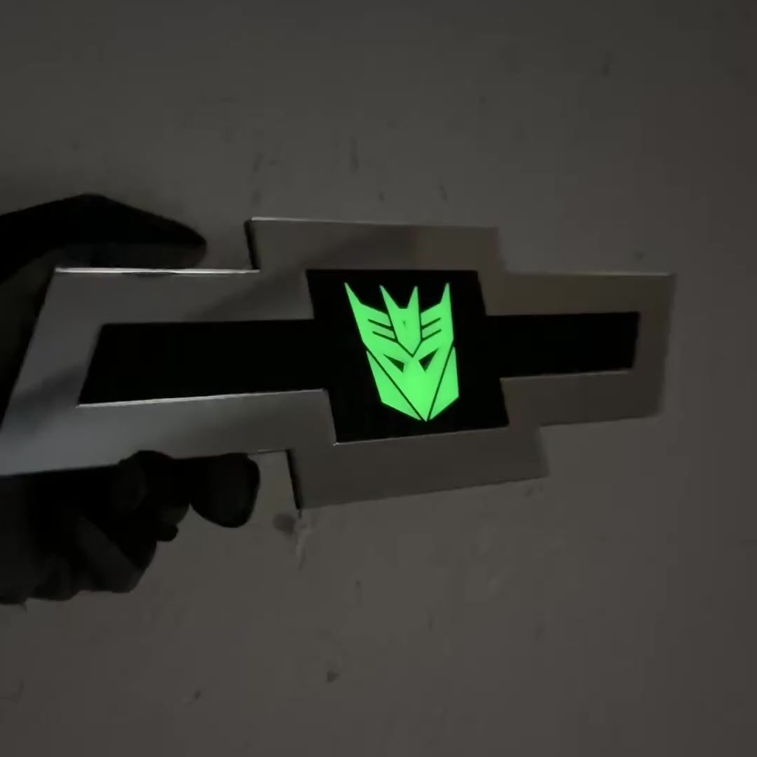 Silver Chevy Bowtie badge featuring a glow Decepticon symbol on black inser
