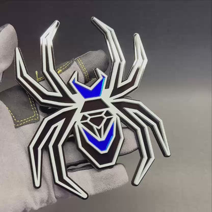 Custom Black Widow spider fender emblem in gray and black with reflective mirror blue details.