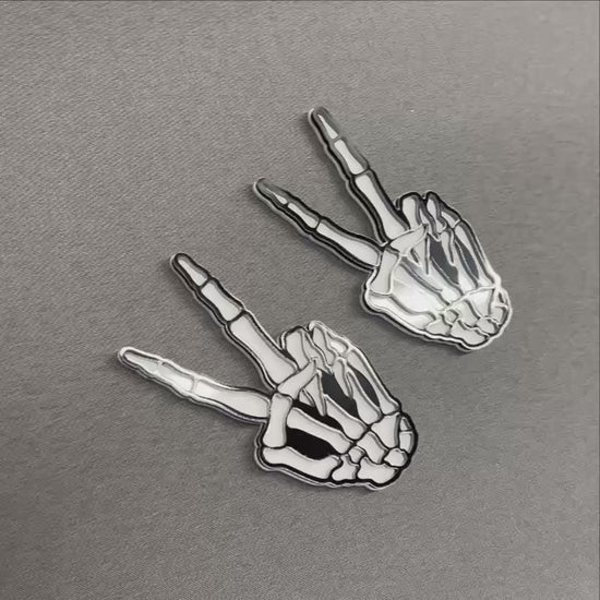 Hang loose bone hand auto badge with black outline and white details.