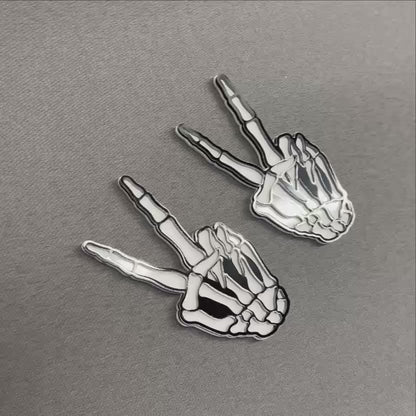 Hang loose bone hand auto badge with black outline and white details.