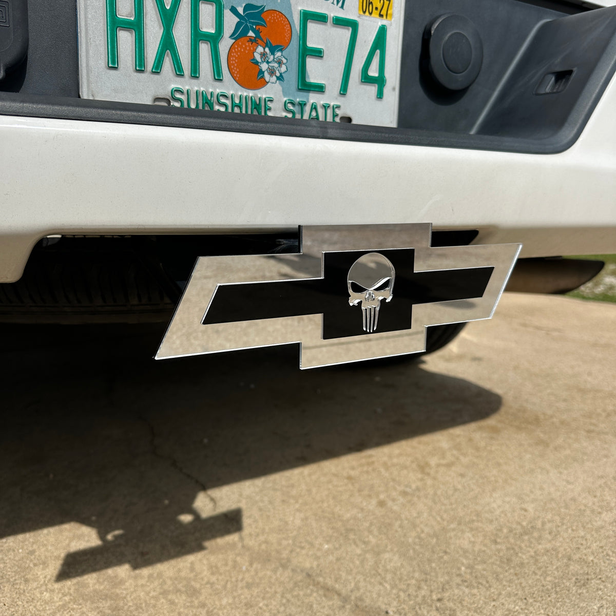 Chevrolet Bowtie hitch emblem with Punisher skull design in silver and blac