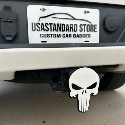 White Punisher skull receiver hitch cover with black border installed on vehicle