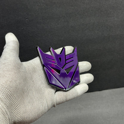 Back of purple Decepticon car emblem with automotive 3M adhesive peel-and-stick backing