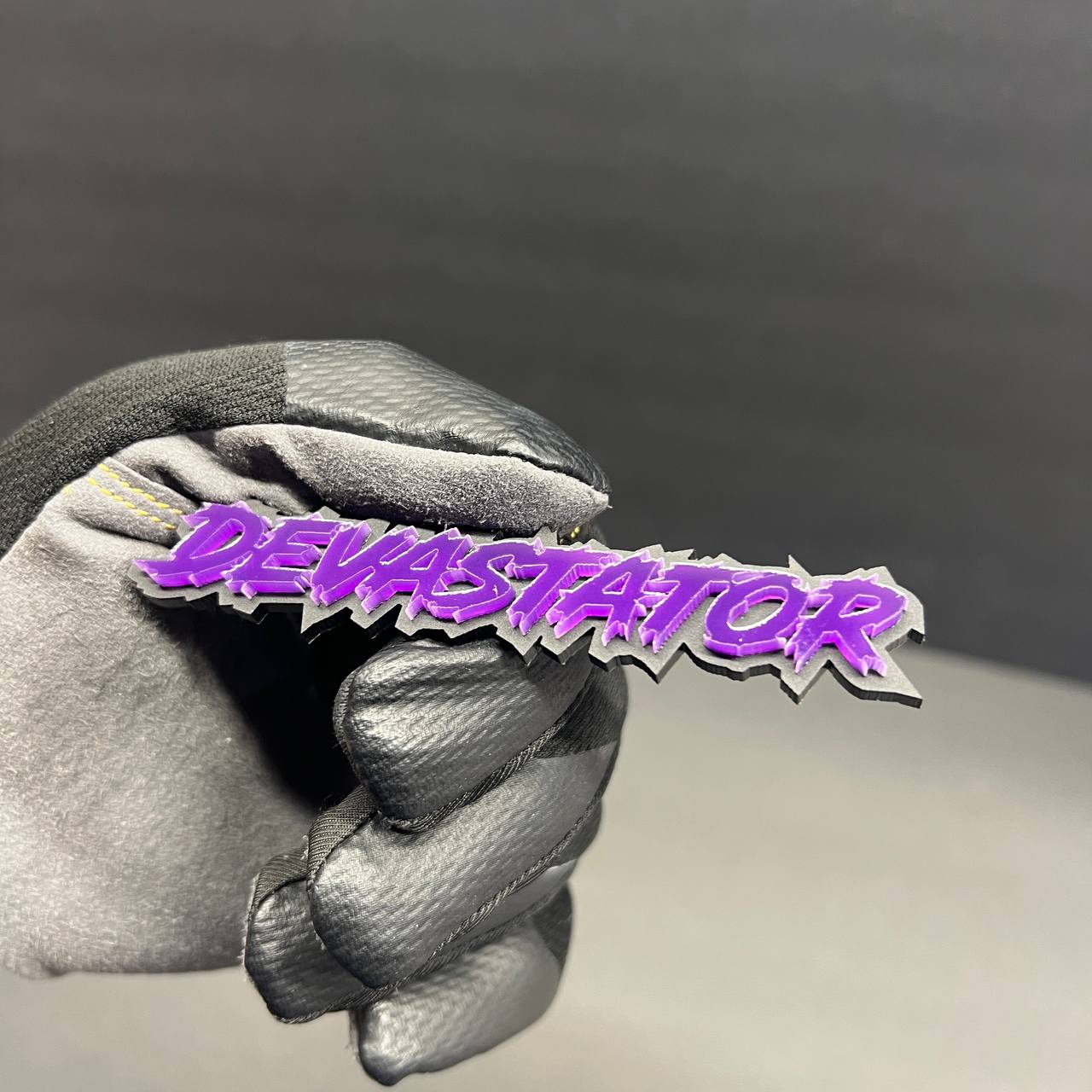 Purple custom text badge with sharp performance inspired lettering style