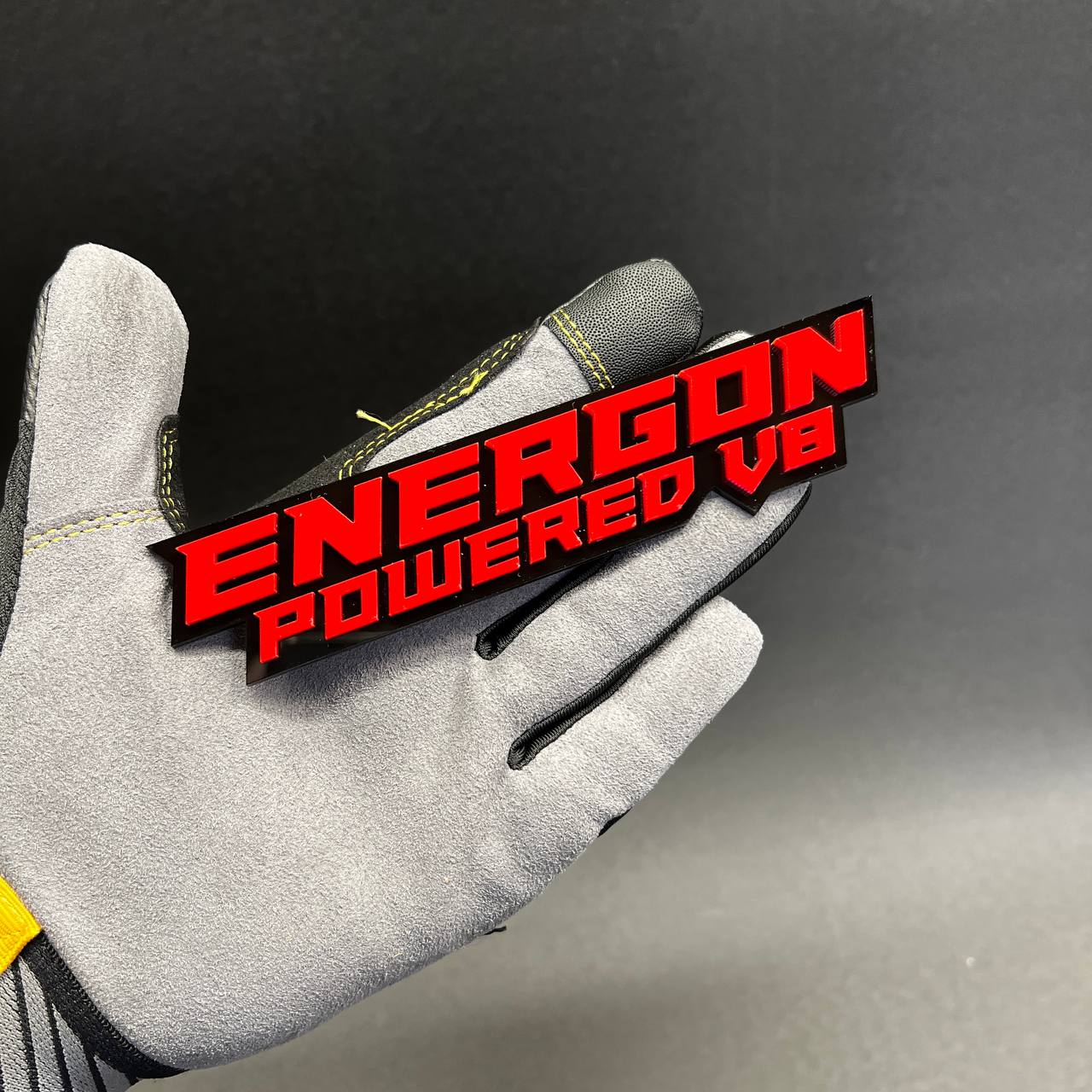 Raised letter performance badge made from layered acrylic for custom vehicle styling.