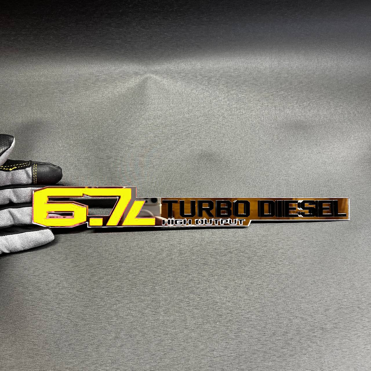 Aftermarket diesel fender badge for 6.7L turbo truck performance styling.