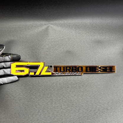 Aftermarket diesel fender badge for 6.7L turbo truck performance styling.