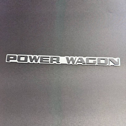 Dodge Ram Power Wagon 4x4 off road truck fender emblem with raised black and silver lettering and adhesive backing.