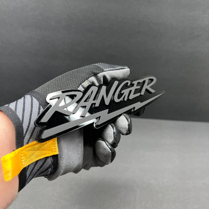 Black and silver custom text car badge with Ranger inspired script font and lightning design for automotive exterior
