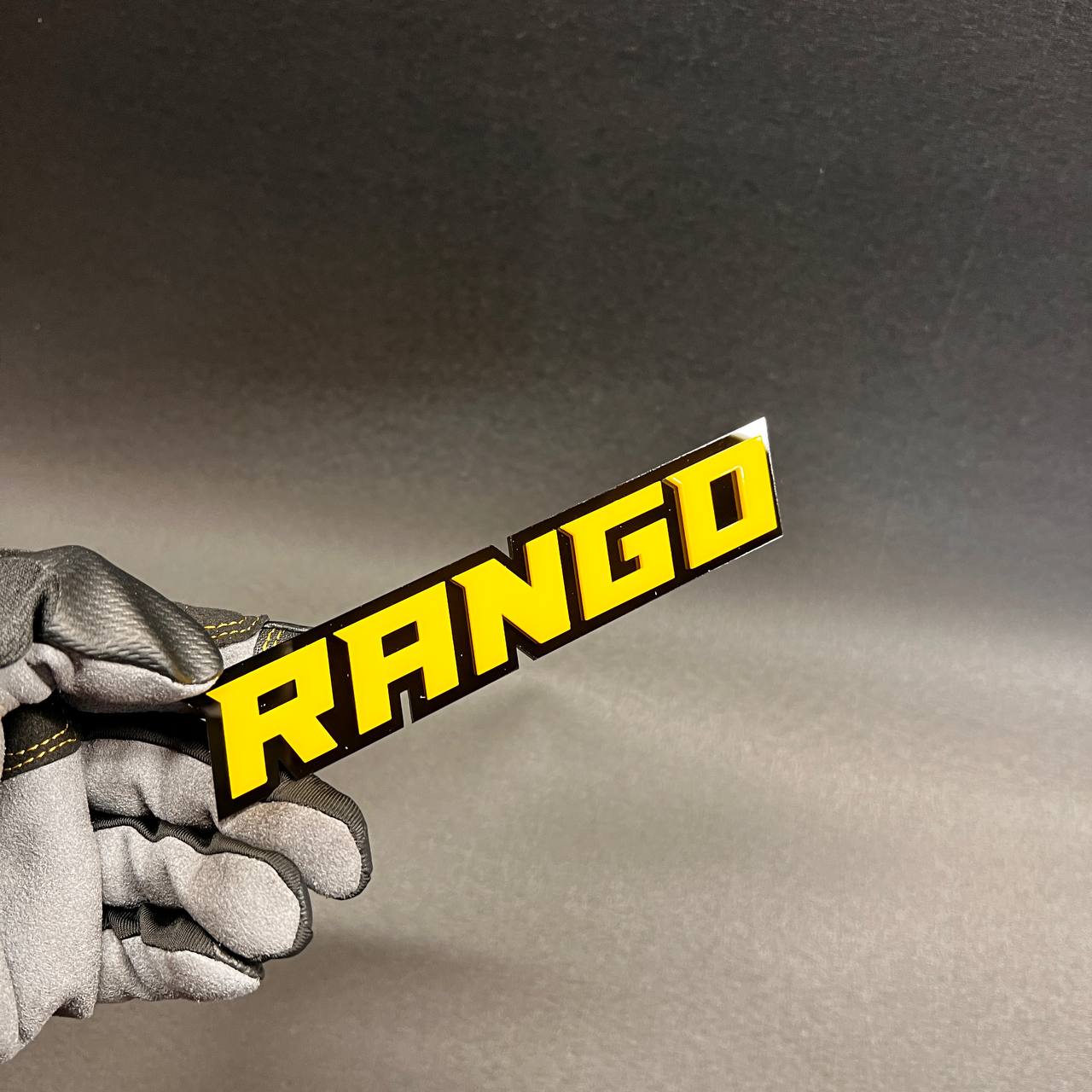 Premium Rango automotive emblem with durable 3D raised letters.