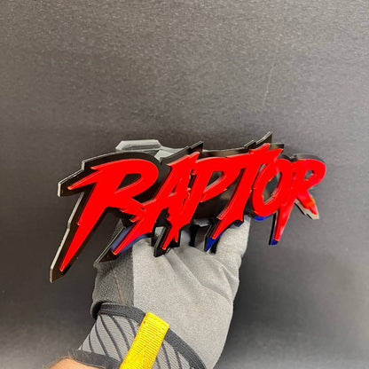 Custom red and black RAPTOR hitch plug accessory for trucks and SUVs