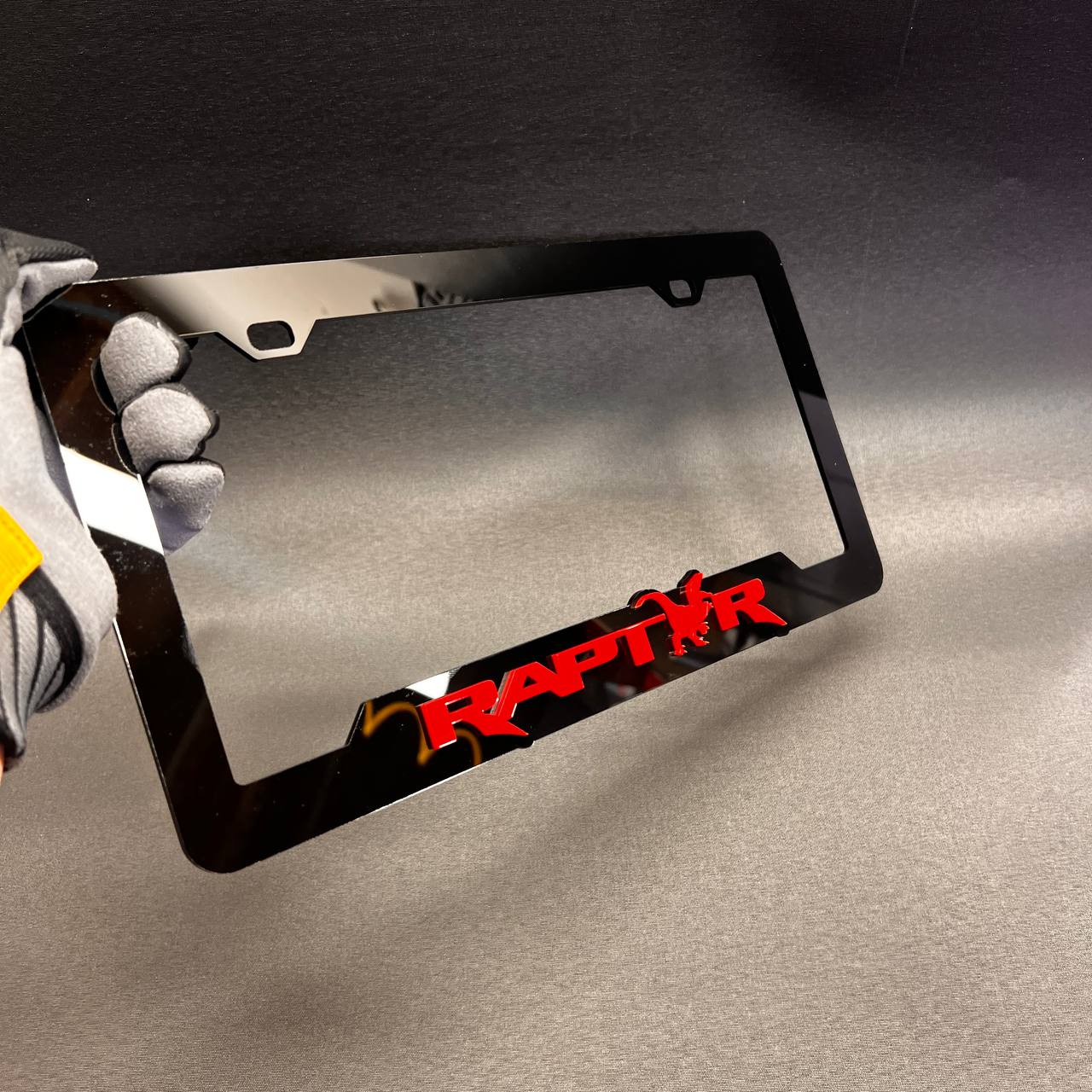 Custom Raptor style license plate frame with bold red graphic detail