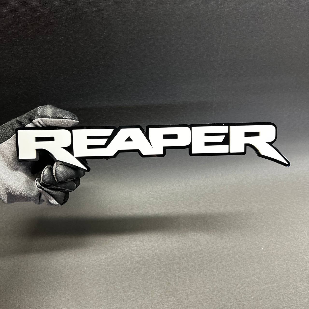 Reaper custom acrylic text badge with black outline for truck fender emblem styling