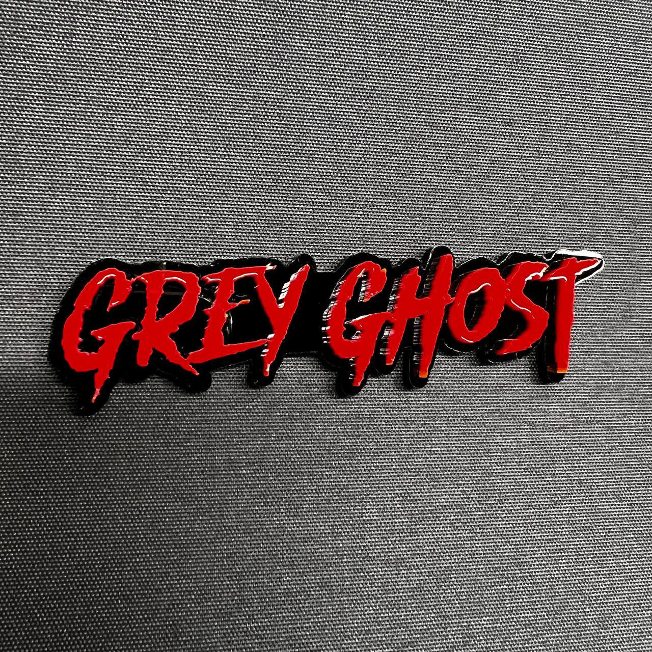 Custom Grey Ghost acrylic script badge with glossy red lettering and black outline for muscle truck hood or tailgate emblem upgrade